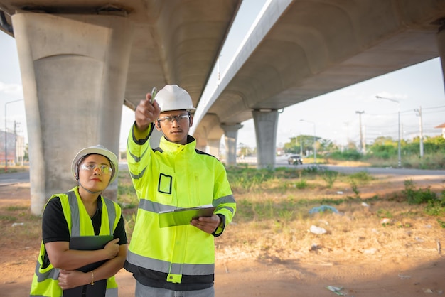 two engineers discuss about work site large bridge constructionmanagement consulting people discussion with engineers about progress construction planning highway 44277 16467